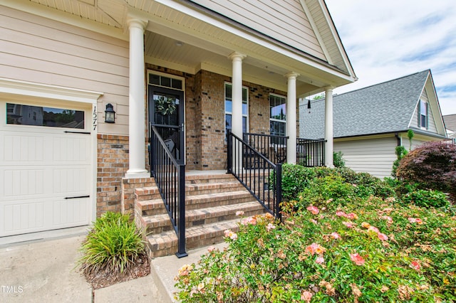 1577 Tice Hurst Ln, Apex, NC 27502 - view of exterior entry featuring covered porch, brick siding, and an attached garage