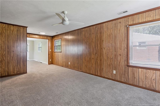 1486 Thelbert Dr, Fayetteville, NC 28301 - carpeted empty room with wooden walls, ceiling fan, and baseboards