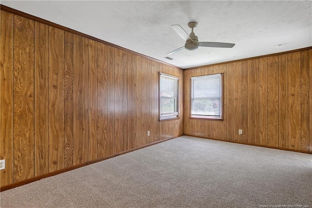 1486 Thelbert Dr, Fayetteville, NC 28301 - spare room featuring a ceiling fan, carpet, a textured ceiling, wood walls, and baseboards