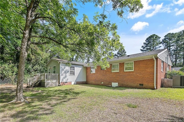 1486 Thelbert Dr, Fayetteville, NC 28301 - back of property with crawl space, a lawn, a wooden deck, brick siding, and cooling unit