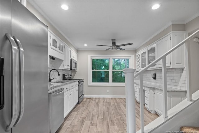 1720 Paisley Ave, Fayetteville, NC 28304 - kitchen featuring stainless steel appliances, a sink, white cabinets, tasteful backsplash, and recessed lighting