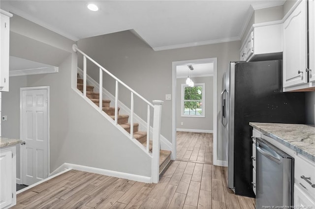 1720 Paisley Ave, Fayetteville, NC 28304 - kitchen featuring stainless steel appliances, light wood-style flooring, crown molding, baseboards, and white cabinets