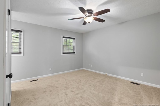 1720 Paisley Ave, Fayetteville, NC 28304 - empty room with light colored carpet, a ceiling fan, a textured ceiling, and baseboards