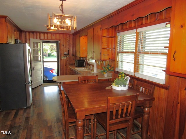 1700 Warrenton Rd, Henderson, NC 27537 - dining area with a chandelier, crown molding, wood walls, and dark wood finished floors