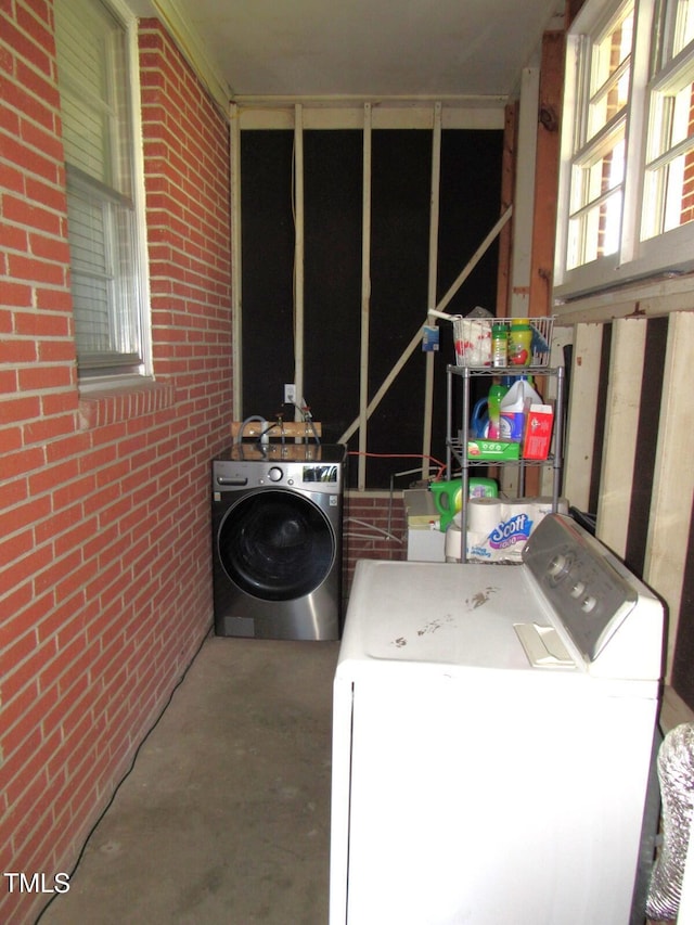 1700 Warrenton Rd, Henderson, NC 27537 - laundry area with washer and dryer and brick wall