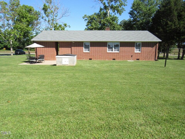 1700 Warrenton Rd, Henderson, NC 27537 - view of home's exterior with crawl space, a lawn, a patio, and brick siding