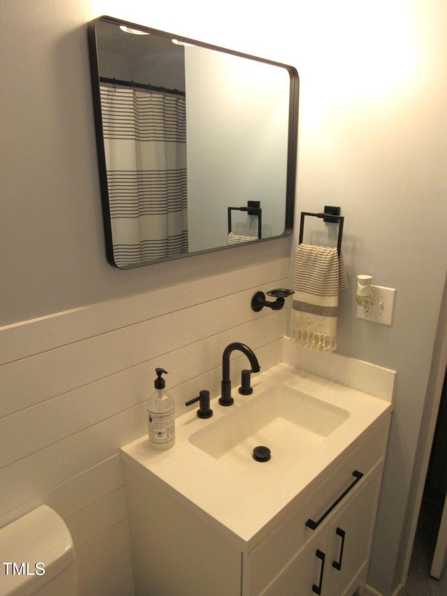 1700 Warrenton Rd, Henderson, NC 27537 - bathroom featuring vanity, tasteful backsplash, toilet, and tile walls
