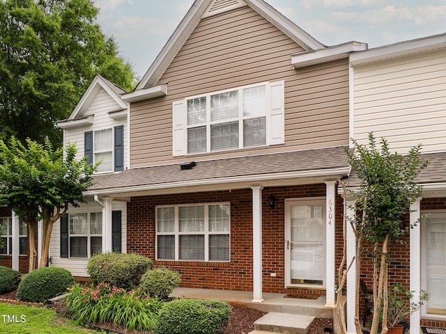 6304 Bermuda Way, Whitsett, NC 27377 - view of front of house featuring brick siding