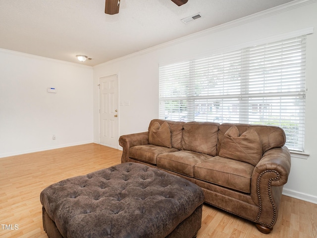 6304 Bermuda Way, Whitsett, NC 27377 - living room featuring light wood finished floors, a ceiling fan, and crown molding