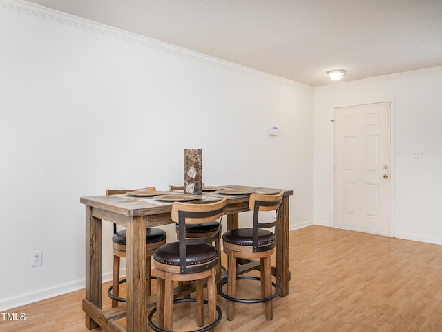 6304 Bermuda Way, Whitsett, NC 27377 - dining area with ornamental molding and light wood-style floors