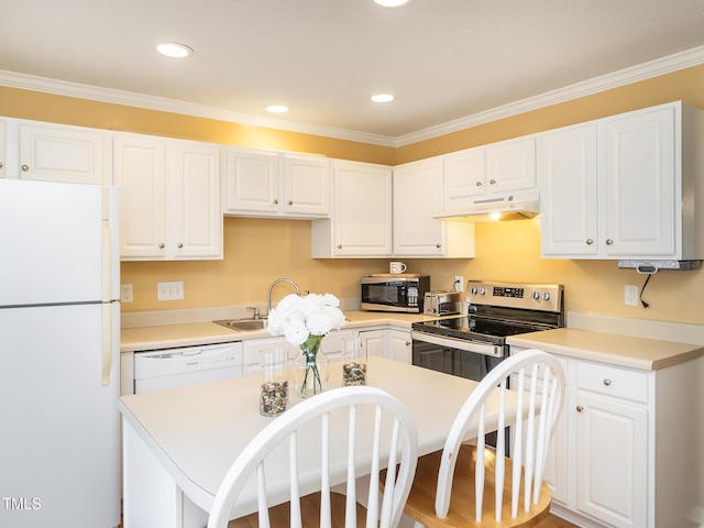 6304 Bermuda Way, Whitsett, NC 27377 - kitchen with stainless steel appliances, under cabinet range hood, white cabinetry, crown molding, and light countertops