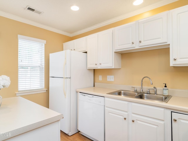 6304 Bermuda Way, Whitsett, NC 27377 - kitchen with white appliances, white cabinets, ornamental molding, light countertops, and recessed lighting