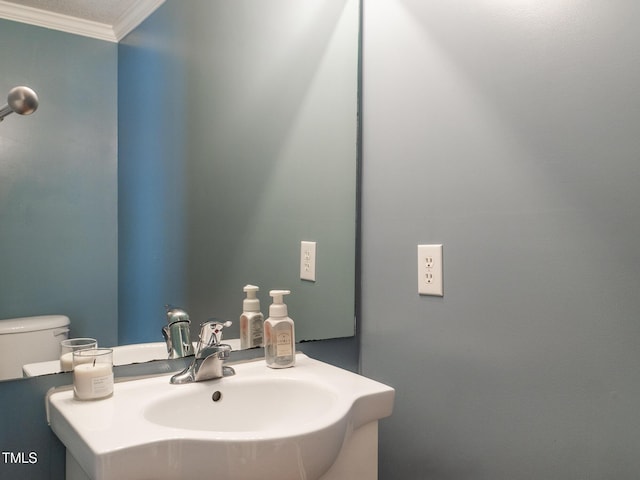 6304 Bermuda Way, Whitsett, NC 27377 - half bath with crown molding and a sink