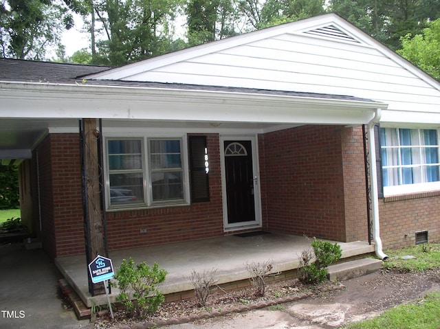 1809 S Garnett Ext, Henderson, NC 27536 - view of front of house with brick siding, covered porch, and crawl space