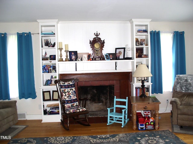 1809 S Garnett Ext, Henderson, NC 27536 - living room with wood finished floors and a fireplace with flush hearth