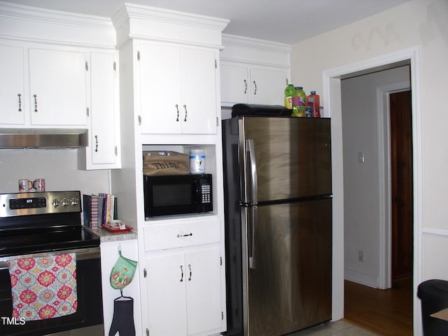 1809 S Garnett Ext, Henderson, NC 27536 - kitchen featuring appliances with stainless steel finishes, exhaust hood, and white cabinetry