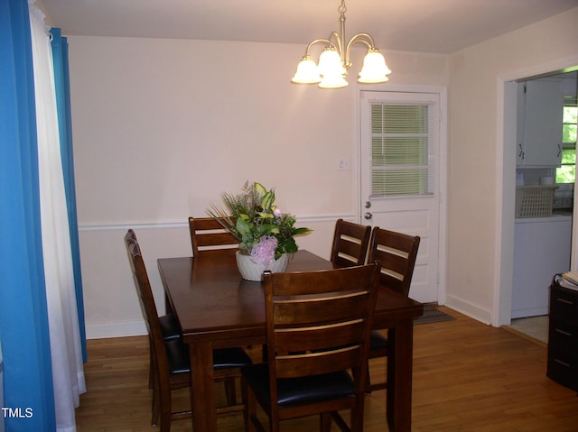 1809 S Garnett Ext, Henderson, NC 27536 - dining room with a chandelier, wood finished floors, and baseboards