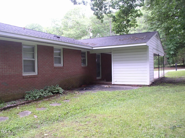 1809 S Garnett Ext, Henderson, NC 27536 - back of property featuring brick siding, a lawn, and a shingled roof