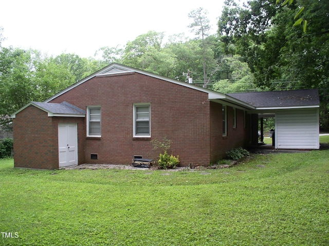 1809 S Garnett Ext, Henderson, NC 27536 - back of property with crawl space, a yard, brick siding, and roof with shingles