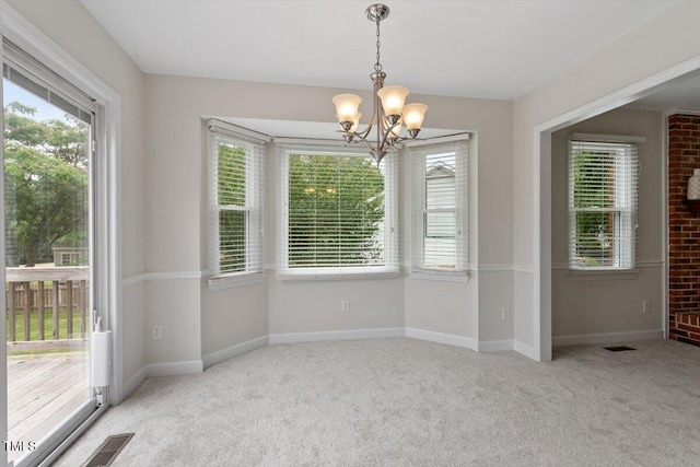 1228 Shakentown St, Knightdale, NC 27545 - unfurnished dining area with carpet floors, a chandelier, and baseboards