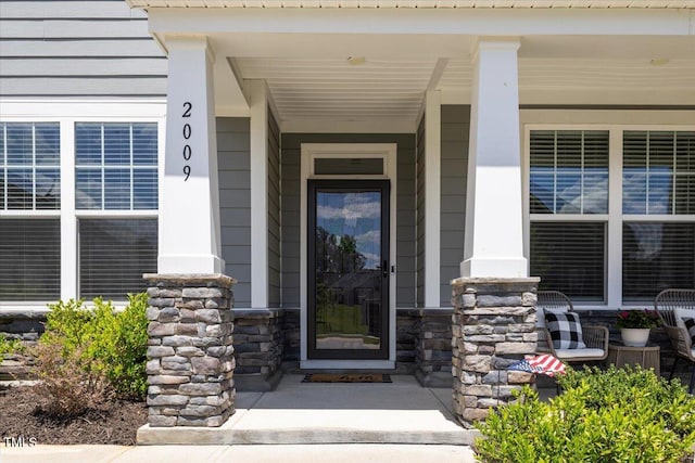 2009 Latham Oaks Ave, Wake Forest, NC 27587 - view of exterior entry featuring a porch and stone siding