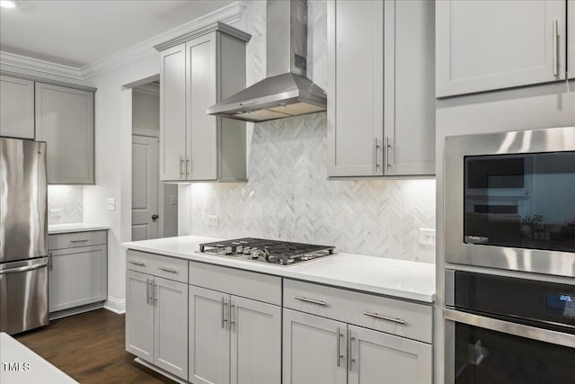 2009 Latham Oaks Ave, Wake Forest, NC 27587 - kitchen with appliances with stainless steel finishes, wall chimney exhaust hood, gray cabinetry, ornamental molding, and light countertops