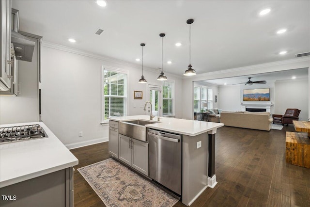 2009 Latham Oaks Ave, Wake Forest, NC 27587 - kitchen with stainless steel appliances, a sink, healthy amount of natural light, ornamental molding, and light countertops
