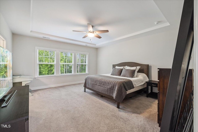 2009 Latham Oaks Ave, Wake Forest, NC 27587 - carpeted bedroom with a tray ceiling, baseboards, and ceiling fan