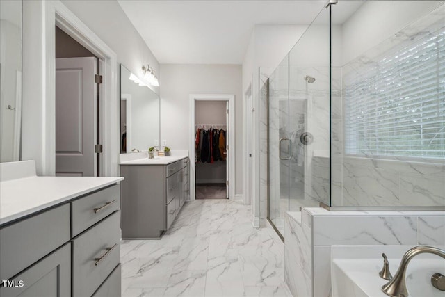 2009 Latham Oaks Ave, Wake Forest, NC 27587 - full bath with a marble finish shower, vanity, marble look tiles, a bath, and a spacious closet