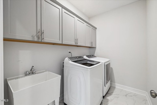 2009 Latham Oaks Ave, Wake Forest, NC 27587 - washroom featuring cabinet space, washing machine and dryer, baseboards, and light marble finish flooring