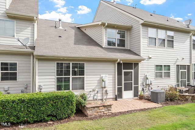 9327 Falkwood Rd, Raleigh, NC 27617 - back of house featuring a patio area, central air condition unit, a sunroom, roof with shingles, and a yard
