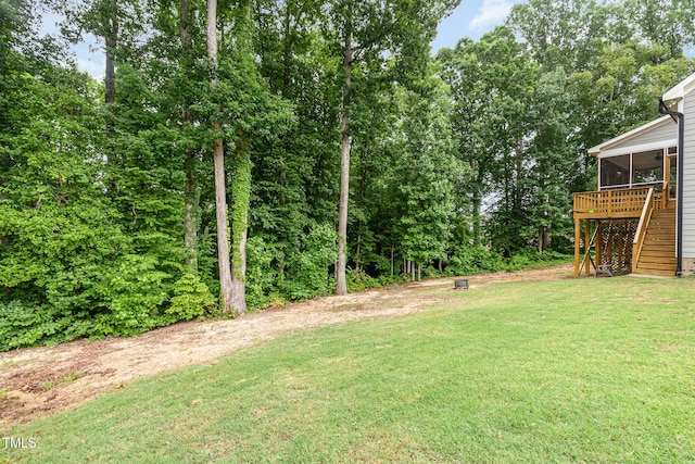 90 Starwood Dr, Garner, NC 27529 - view of green lawn with stairs, a sunroom, and a wooden deck