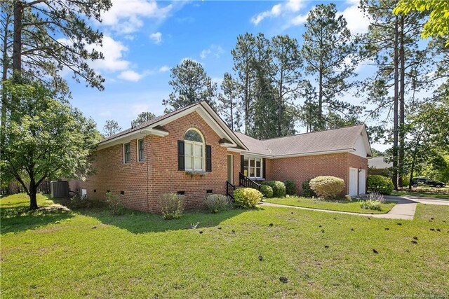 7578 Firethorn Dr, Fayetteville, NC 28311 - view of front of home featuring crawl space, brick siding, a front yard, and an attached garage