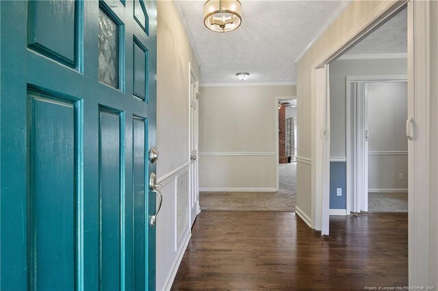 7578 Firethorn Dr, Fayetteville, NC 28311 - foyer entrance with a textured ceiling, dark wood-type flooring, and ornamental molding