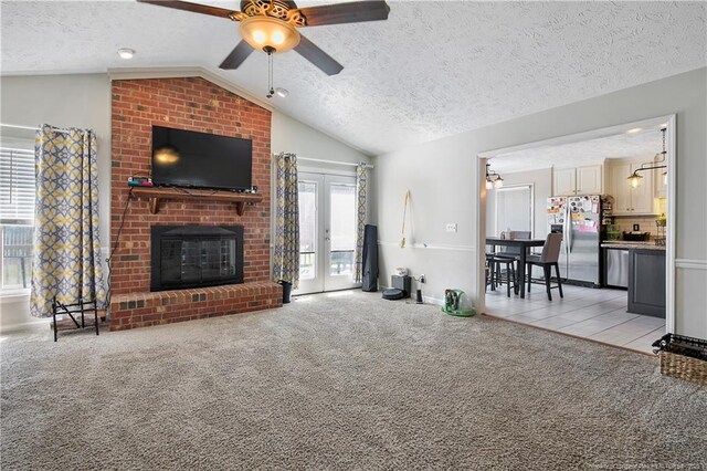7578 Firethorn Dr, Fayetteville, NC 28311 - living room with a textured ceiling, lofted ceiling, a ceiling fan, light colored carpet, and a brick fireplace