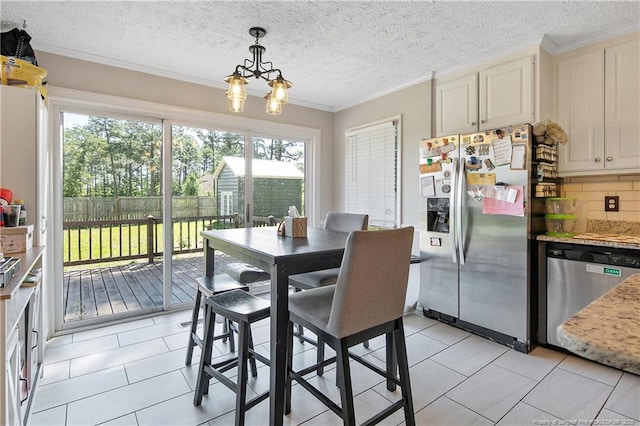 7578 Firethorn Dr, Fayetteville, NC 28311 - dining room featuring a chandelier, ornamental molding, light tile patterned flooring, and a textured ceiling