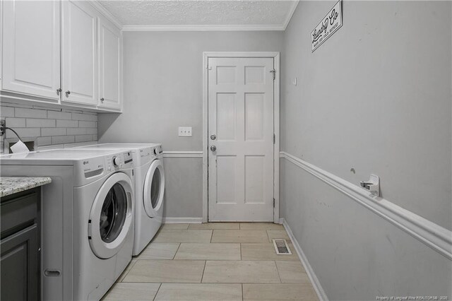 7578 Firethorn Dr, Fayetteville, NC 28311 - laundry area featuring cabinet space, washing machine and clothes dryer, baseboards, a textured ceiling, and ornamental molding