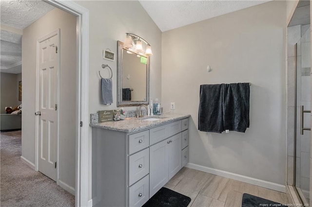 7578 Firethorn Dr, Fayetteville, NC 28311 - full bathroom featuring vanity, a textured ceiling, baseboards, and a shower with door