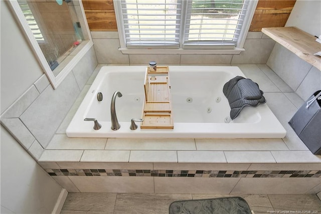 7578 Firethorn Dr, Fayetteville, NC 28311 - bathroom featuring healthy amount of natural light and a tub with jets