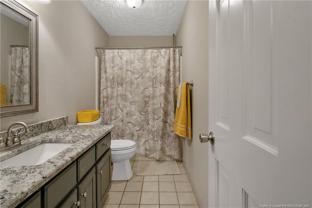 7578 Firethorn Dr, Fayetteville, NC 28311 - bathroom featuring vanity, toilet, tile patterned floors, a textured ceiling, and baseboards
