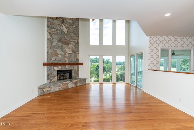 112 Lancaster Dr, Chapel Hill, NC 27517 - unfurnished living room featuring baseboards, a fireplace, wood finished floors, and ceiling fan