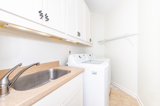 112 Lancaster Dr, Chapel Hill, NC 27517 - washroom with washing machine and dryer, cabinet space, light tile patterned floors, and baseboards