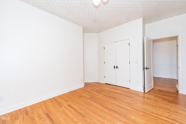 112 Lancaster Dr, Chapel Hill, NC 27517 - unfurnished bedroom featuring light wood-style flooring, baseboards, and a closet