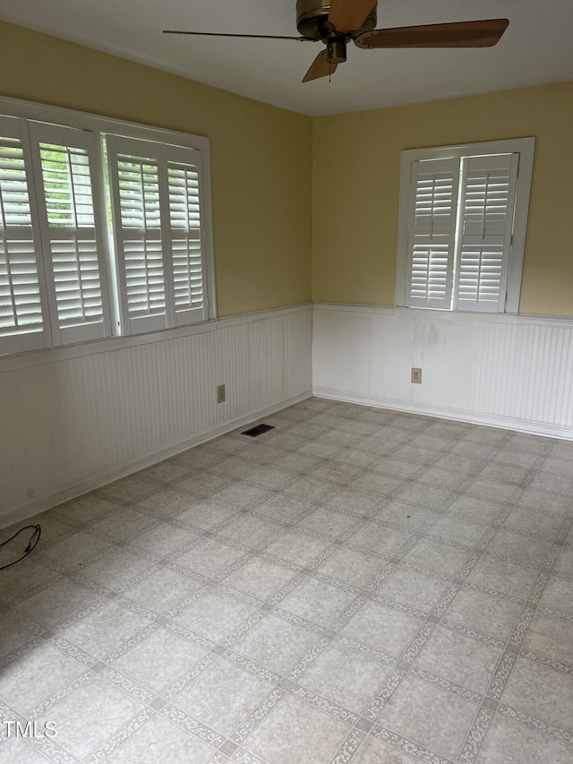 806 Ethelored St, Fayetteville, NC 28303 - empty room with a ceiling fan and a wainscoted wall