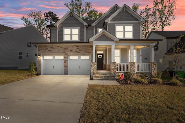 604 Craftsman Ridge Trl, Knightdale, NC 27545 - craftsman-style home featuring a porch, driveway, an attached garage, a front yard, and stone siding