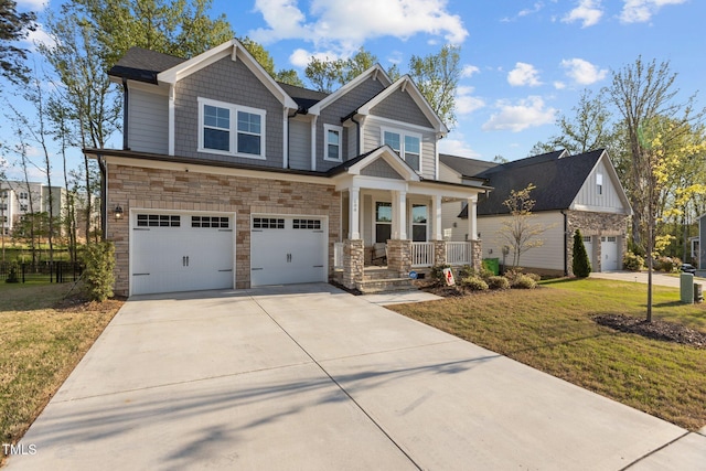 604 Craftsman Ridge Trl, Knightdale, NC 27545 - craftsman-style house featuring a porch, driveway, stone siding, and a front lawn
