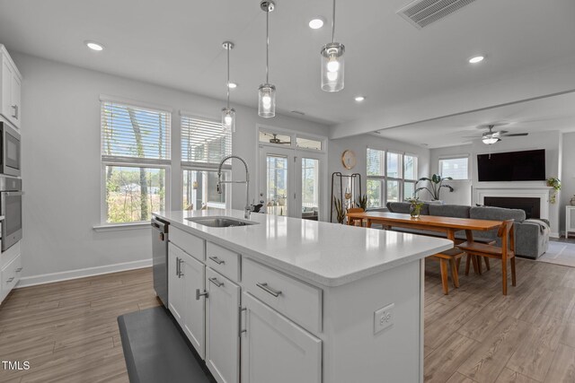 604 Craftsman Ridge Trl, Knightdale, NC 27545 - kitchen featuring a sink, a fireplace, stainless steel appliances, recessed lighting, and baseboards
