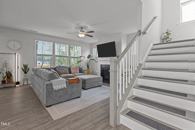 604 Craftsman Ridge Trl, Knightdale, NC 27545 - living room with healthy amount of natural light, ceiling fan, stairs, and a fireplace
