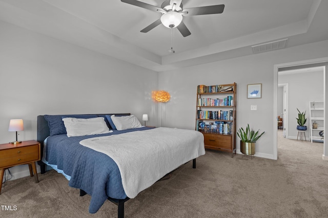 604 Craftsman Ridge Trl, Knightdale, NC 27545 - carpeted bedroom with a tray ceiling, baseboards, and a ceiling fan