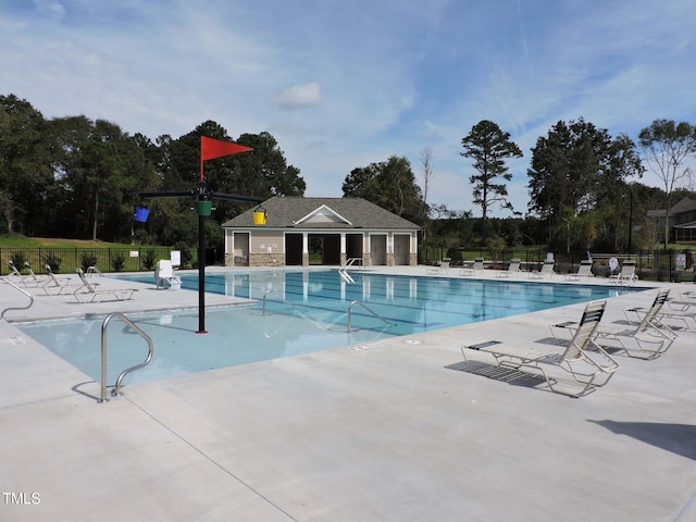 604 Craftsman Ridge Trl, Knightdale, NC 27545 - community pool featuring a patio and view of wooded area